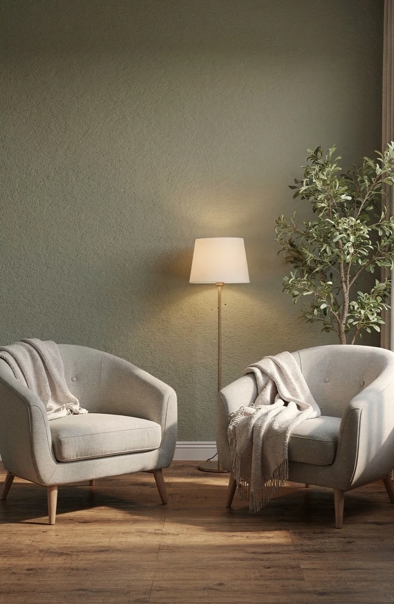 A quiet, grounding therapy room with two facing armchairs and a leafy plant